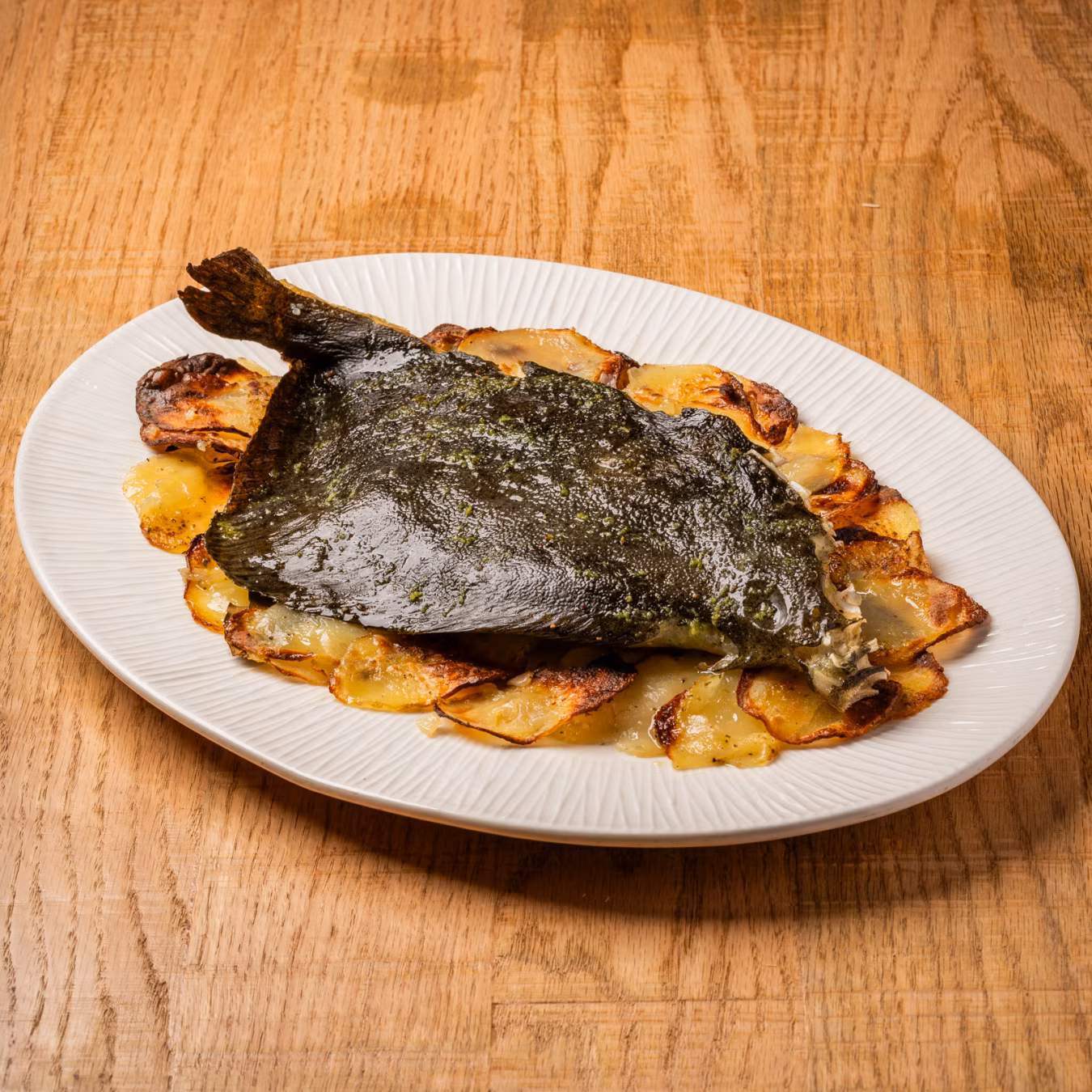 Baked turbot with sliced potatoes